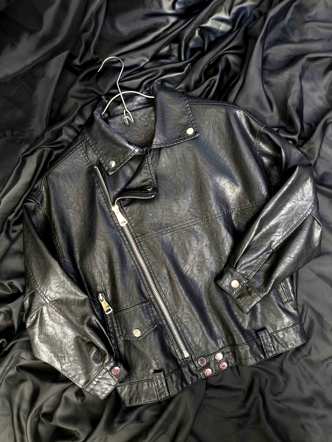 Black leather jacket laid flat after cleaning and conditioning